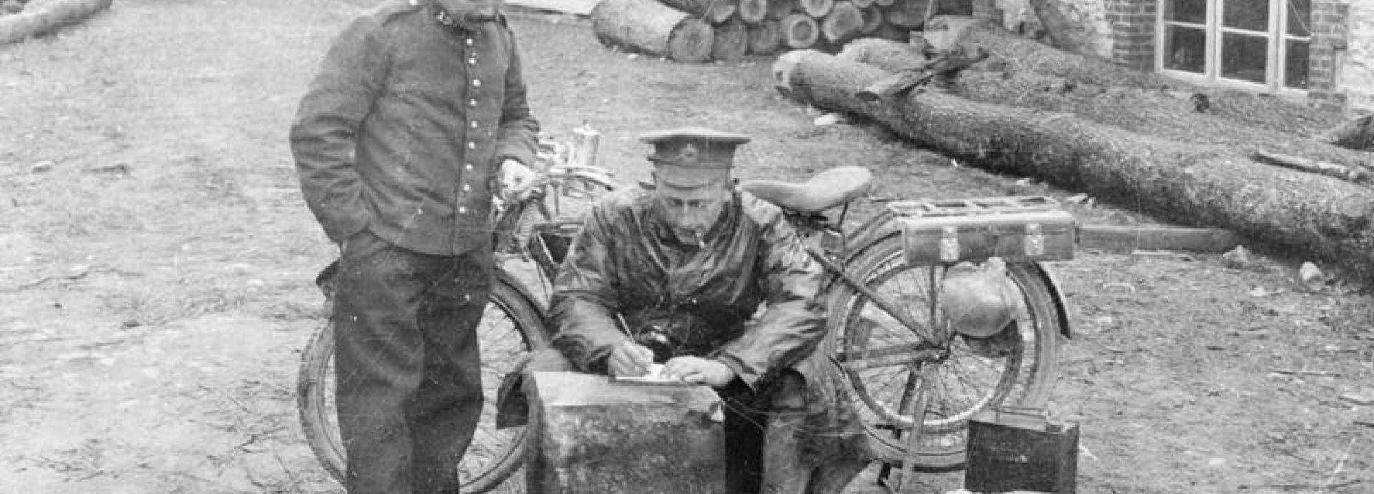 A British motorcycle dispatch rider takes a message in a Belgian village on 16 October 1914 - IWM Non-commercial license - Q 53338